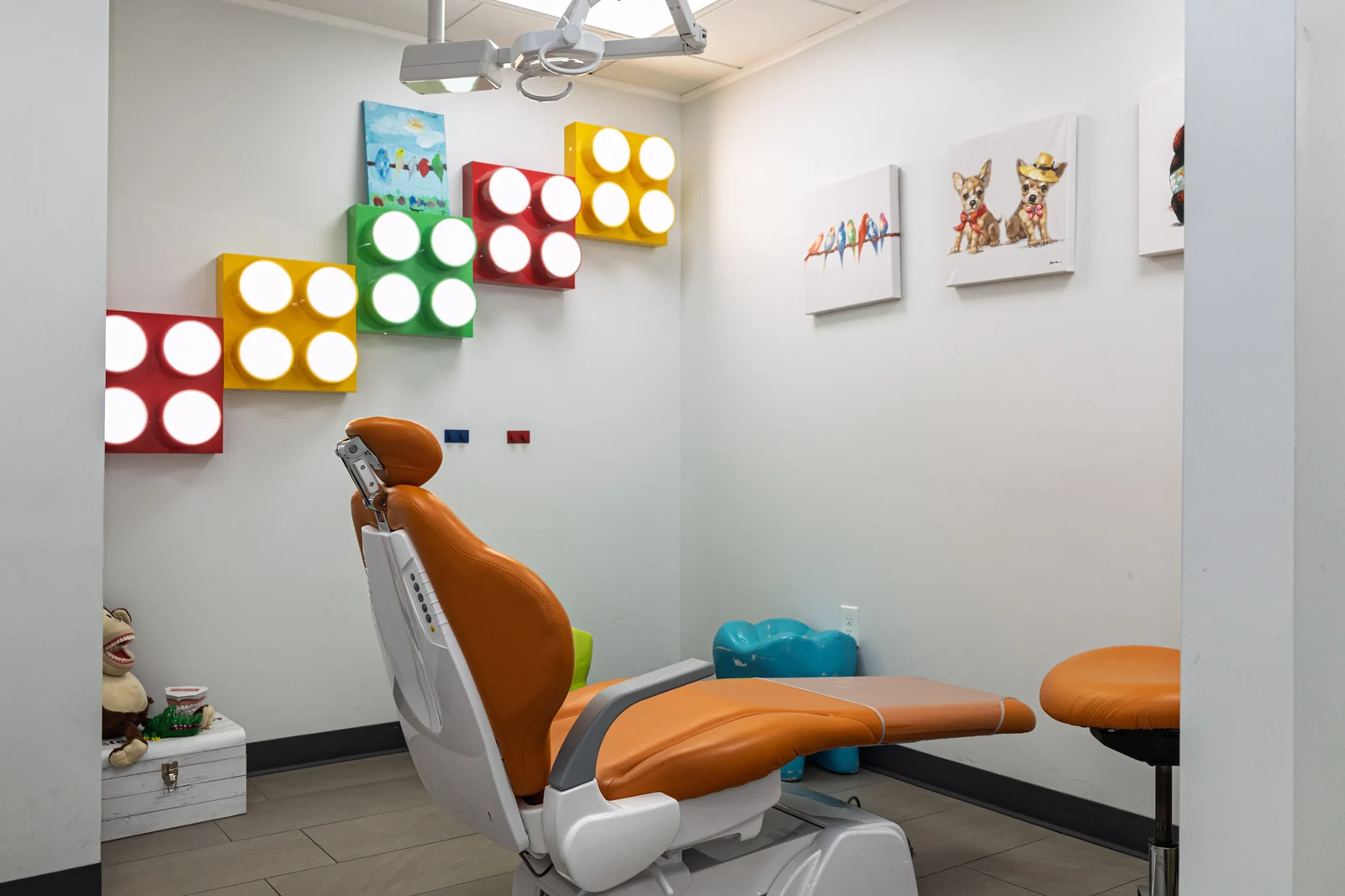 A young patient in protective glasses smiling beside a SmilePro Dental clinician