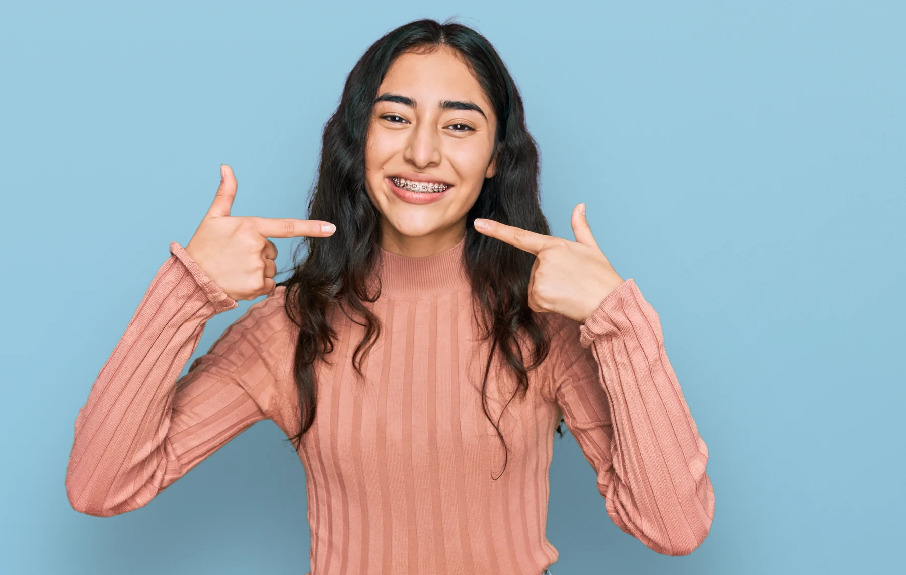 A young patient smiling with braces