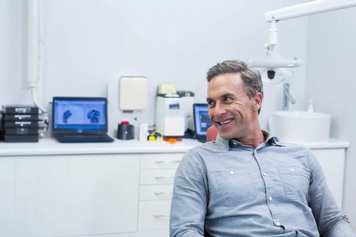 A smiling man in his forties relaxing in the dental chair — Dental Implants at SmilePro Dental