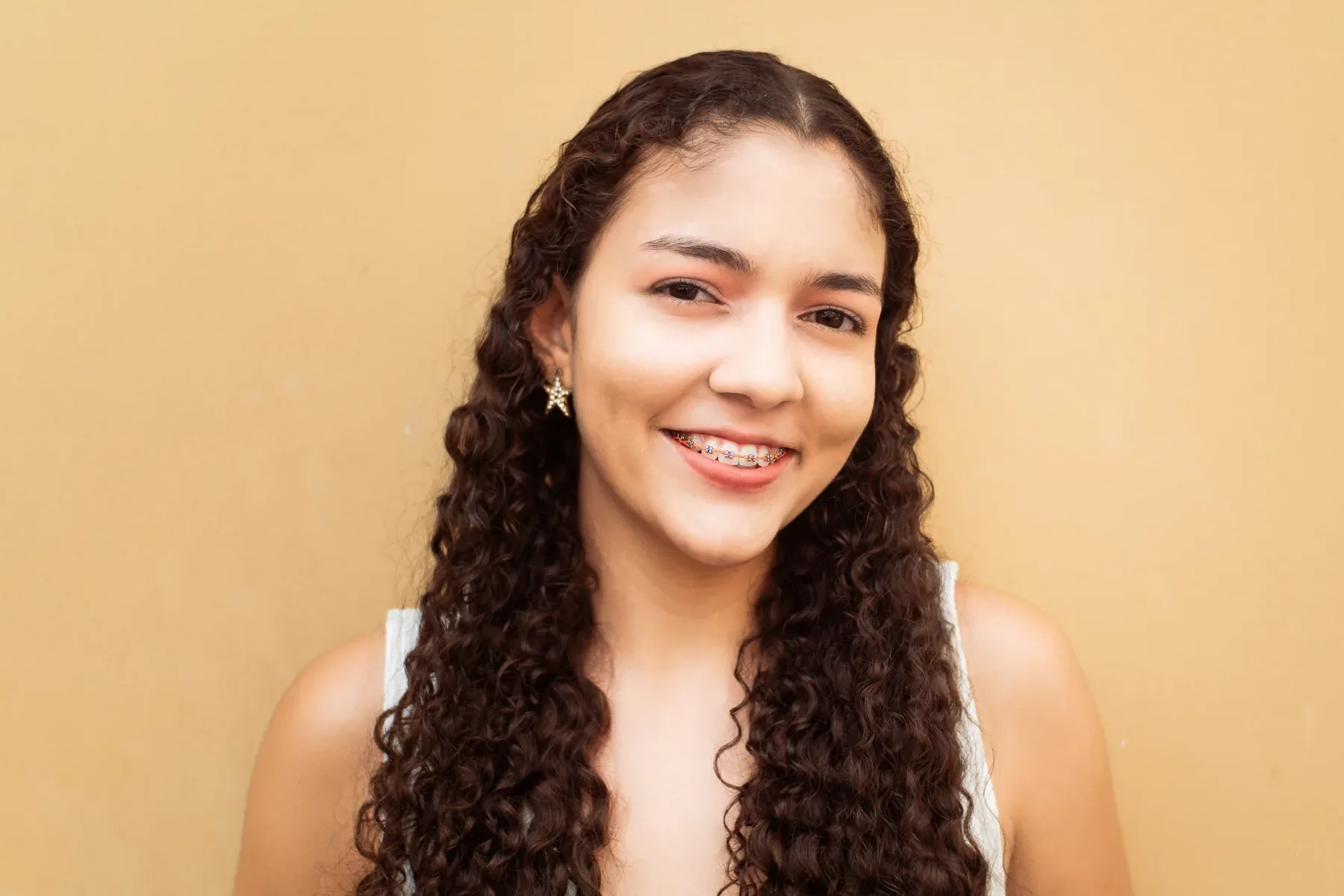A smiling young woman with braces